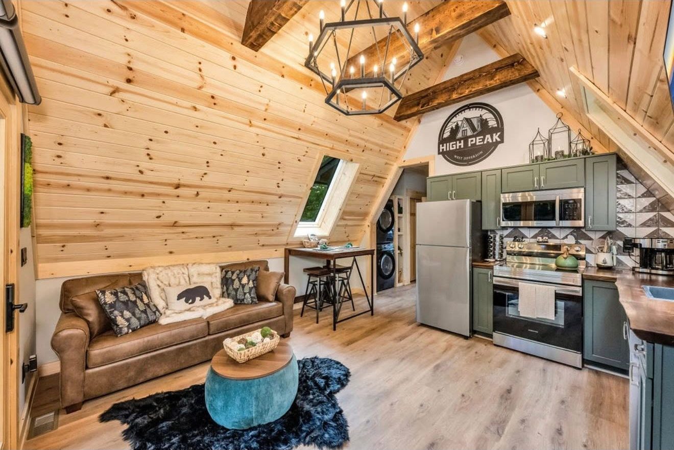 The cabin interior with timber ceiling, kitchen and living space
