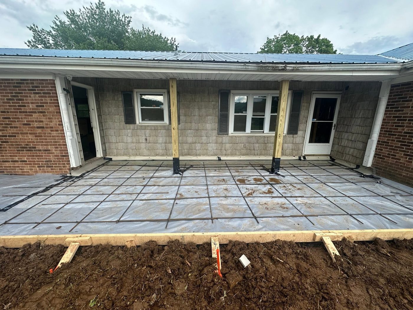 A concrete patio and rear addition under construction