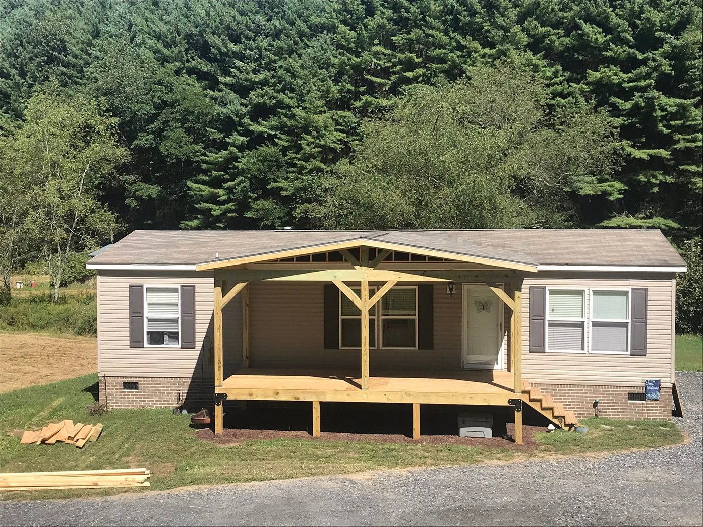 A covered porch addition built onto a home
