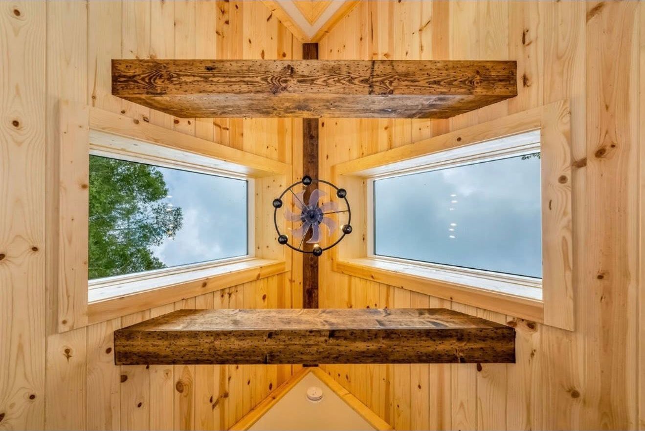 A timber beam and window detail inside the cabin